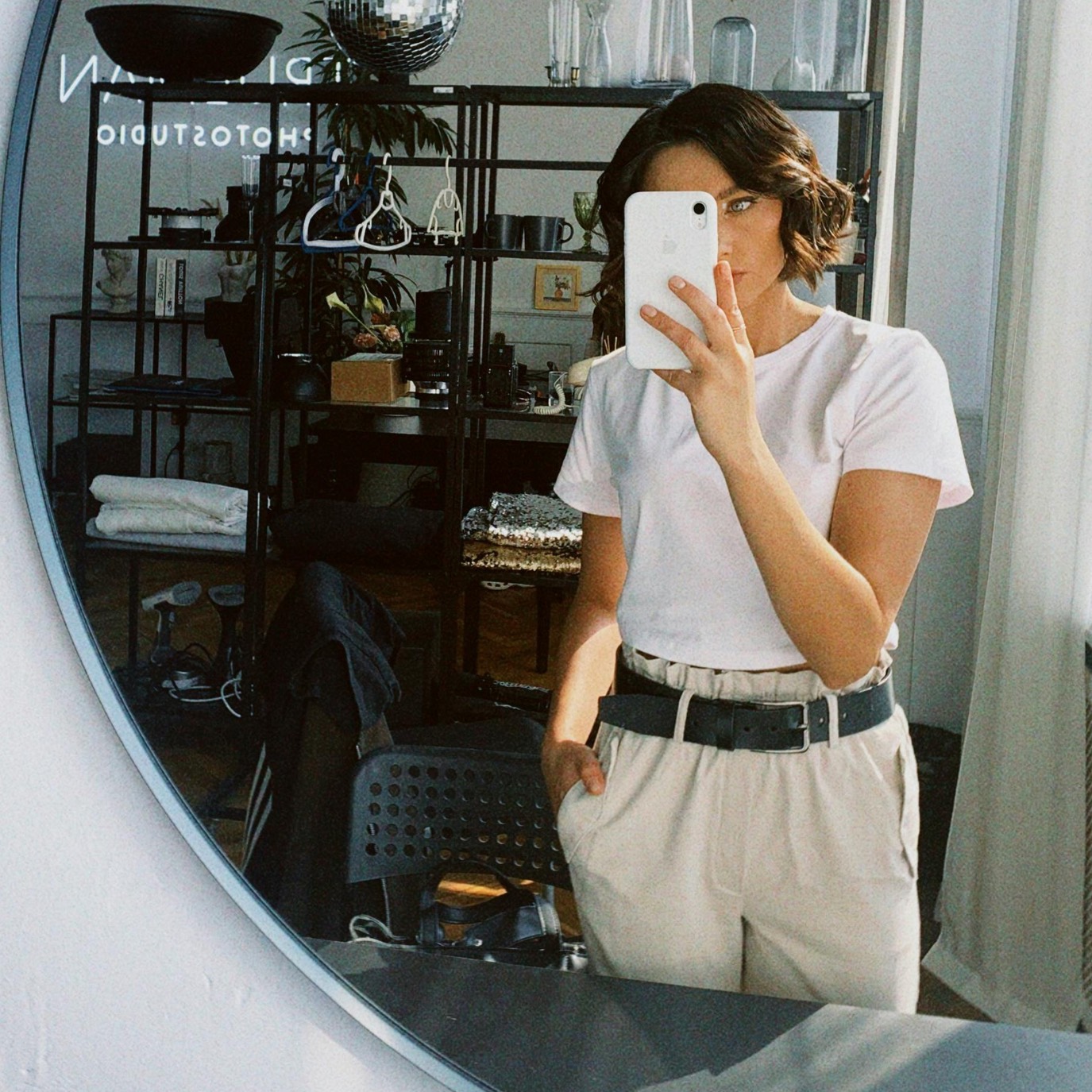 mirror selfie showing a content creator trying on clothes